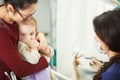 Mother holds child that afraid of examination by dentist