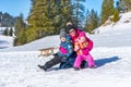 Mother holds children in her arms on the snow