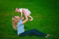 Mother holds on a hands her little baby on a grass Royalty Free Stock Photo