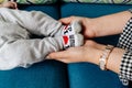 Mother holds her baby`s feet in her hands, socks labeled `I love Mum Royalty Free Stock Photo