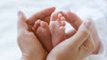 Mother holds legs newborn baby Royalty Free Stock Photo