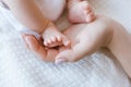 Mother holds legs newborn baby Royalty Free Stock Photo