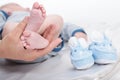 Mother holds legs of the newborn child Royalty Free Stock Photo