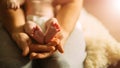 Mother holds newborn baby`s feets. Tiny feet in woman`s hand. Royalty Free Stock Photo