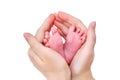 The mother holds the small child foot in her palms. Large female hand Royalty Free Stock Photo