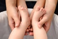 A mother holds the small legs of her newborn baby in her hands. Royalty Free Stock Photo