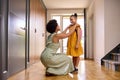 Mother At Home Helping Daughter Getting Ready To Go To School Royalty Free Stock Photo