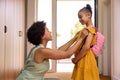 Mother At Home Helping Daughter Getting Ready To Go To School Royalty Free Stock Photo