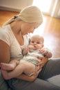 Mother at home holding her baby boy in arms. Royalty Free Stock Photo