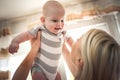 Mother at home holding her little baby boy. Close up. Royalty Free Stock Photo