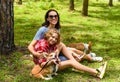 Mother hugging her little daughter resting on her sholder with closed eyes Royalty Free Stock Photo