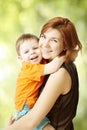 Mother hugging her son. Happy woman and kid smile. Girl and child playing and laughing. Baby on hands at mum Royalty Free Stock Photo