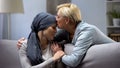 Mother hugging and kissing her hopeless daughter with cancer, family support Royalty Free Stock Photo