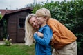 Mother hugging son from behind, bonding moment. Real family, real people. Concept of Mother's Day, and motherly love Royalty Free Stock Photo