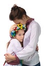 The mother hugs the child with tearful eyes. A child in Ukrainian national clothes