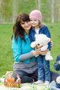 Mother hugs daughter at a picnic