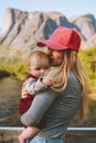 Mother and infant baby together family traveling in mountains