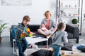 mother with infant child meditating in lotus position while naughty siblings playing