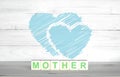 Mother. The inscription on wooden cubes. On a white background. Two hearts