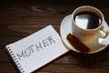 Mother inscription and word in a notebook near a cup of coffee