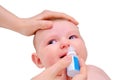 Mother instills nasal drops in Infant baby, face close-up, isolated on a w Royalty Free Stock Photo