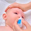 Mother instills nasal drops in Infant baby, face close-up Royalty Free Stock Photo