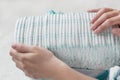 Mother keeps the package with baby diapers, close-up