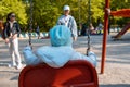 mother with kid at city park children swings Royalty Free Stock Photo