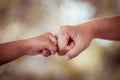 Mother and kid daughter are fist bumping