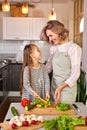 pretty mother and kid girl preparing healthy food for family, vegan salad Royalty Free Stock Photo