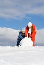 Mother with kid making snowman