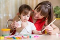 Mother and kid paint together at home Royalty Free Stock Photo