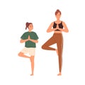 Mother and kid practicing yoga exercises. Mom and child doing asana, standing in Tree Pose together. Parent and daughter