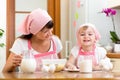 Mother and kid preparing cookies together