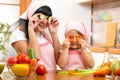 Mother with kid preparing healthy food and having fun Royalty Free Stock Photo