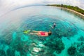 Mother, kid in snorkeling mask dive underwater with tropical fishes Royalty Free Stock Photo