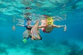 Mother, kid in snorkeling mask dive underwater with tropical fishes Royalty Free Stock Photo