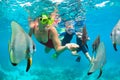 Mother, kid in snorkeling mask dive underwater with tropical fishes Royalty Free Stock Photo