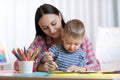 Mother and kid son drawing with colored pencils Royalty Free Stock Photo
