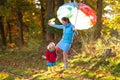 Mother and kids in autumn park. Family in rain Royalty Free Stock Photo