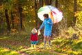 Mother and kids in autumn park. Family in rain Royalty Free Stock Photo