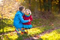 Mother and kids in autumn park. Family in rain Royalty Free Stock Photo