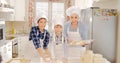 Mother with kids baking. Royalty Free Stock Photo