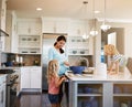 Mother, kids and cookies in kitchen for baking with learning, bonding and preparation in home with teaching. Family Royalty Free Stock Photo