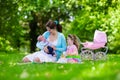 Mother and kids enjoying picnic outdoors