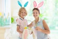 Mother and kids, family coloring Easter eggs Royalty Free Stock Photo