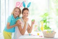 Mother and kids, family coloring Easter eggs Royalty Free Stock Photo