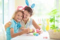 Mother and kids, family coloring Easter eggs Royalty Free Stock Photo