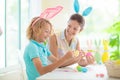 Mother and kids, family coloring Easter eggs Royalty Free Stock Photo