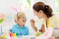 Mother and kids, family coloring Easter eggs Royalty Free Stock Photo